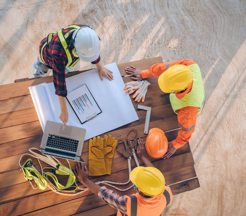 Team of engineer and architects working, meeting, discussing,designing, planning, measuring layout of building blueprints at construction site,Top view,Construction concept.